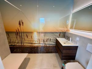 a bathroom with a shower with a view of the ocean at Mel's Pintxos winebar & Aparthotel in Zandvoort +43 photos