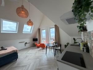 a living room with a table and a dining room at Mel's Pintxos winebar & Aparthotel in Zandvoort