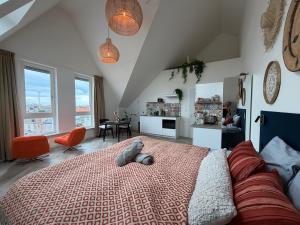 a bedroom with a bed and a living room at Mel's Pintxos winebar & Aparthotel in Zandvoort