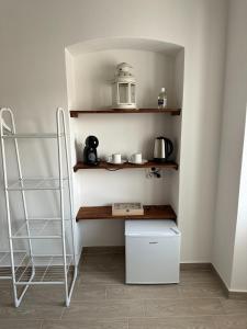 a kitchen with a shelf with a tea pot on it at Affittacamere Ca' Vecia in Riccò del Golfo di Spezia +20 photos