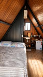 a bedroom with a bed and a sink in a room at Chalé Suiço Diniz e Ferreira in Contagem