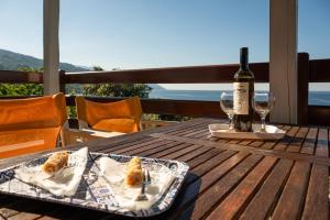 a table with a bottle of wine and a tray of food at Maistros Studios in Damouchari