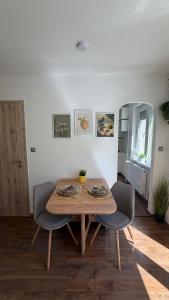 a dining room table and two chairs in a room at Casa Capri Győr in Győr