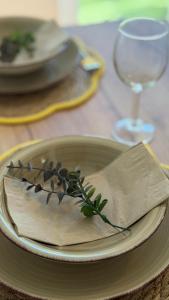 a table with a plate with a napkin and a glass at Casa Capri Győr in Győr +12 photos