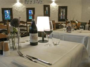 a bottle of wine sitting on a table with glasses at Bijou Alpina Surlej in Silvaplana