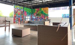 a restaurant with a colorful mural on the wall at Hotel Alecrim in Caxias das Aldeias Altas