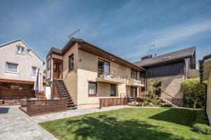 a brick house with a lawn in front of it at Gerika guest house in Palanga