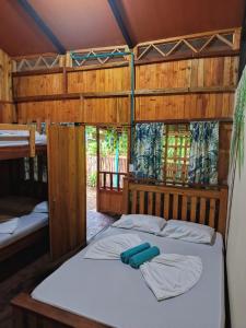 a bed in a room with two bunk beds at La Orquídea Cabañas in Playa Ladrilleros