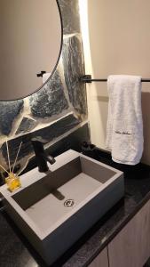 a bathroom sink with a mirror on a counter at Villa Vadori Suites in Falda del Carmen +17 photos