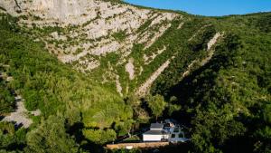 a house in the middle of a mountain at Villa Vrelo Oasis in Malo Polje