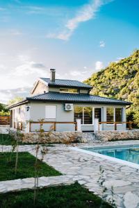 a house with a pool in front of it at Villa Vrelo Oasis in Malo Polje +26 photos