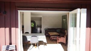 a living room with a table and chairs and a couch at HagestadHytteutleie Wallhall in Birkenes