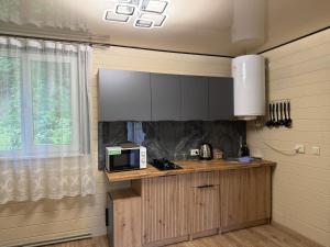 a kitchen with a counter with a microwave and a window at Family House in Izki +31 photos