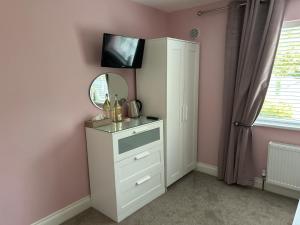 a bathroom with a mirror and a white dresser at Barrow View Accommodation in Mountmellick