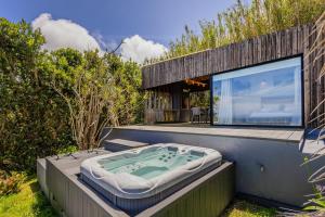 a bath tub sitting on the side of a house at GuestReady - Casa do Horizonte in Mosteiros