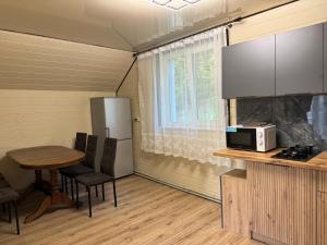a small kitchen with a table and a microwave at Family House in Izki