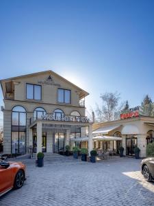 a building with a car parked in front of it at Mountain View Boutique Hotel in Almaty