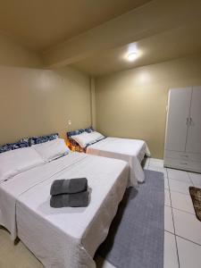 a room with two beds with towels on them at Refugio Centrico Studio 2 in Ciudad del Este