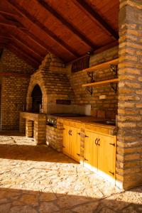 an outdoor kitchen with a counter and a brick wall at Rodjino imanje in Palić