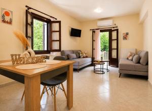 a living room with a table and a couch at Elias Studio & Apartment near Papa Nero Beach Pelion in Agios Ioannis Pelio
