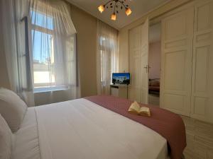 a bedroom with a large bed with two books on it at Theasis Athens in Athens