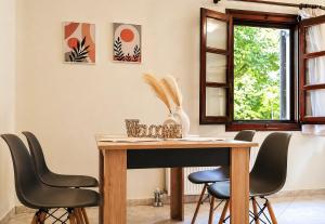 a dining room with a wooden table and chairs at Elias Studio & Apartment near Papa Nero Beach Pelion in Agios Ioannis Pelio