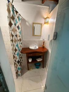 a small bathroom with a sink and a mirror at Arandú Hostel in Itacaré +37 photos