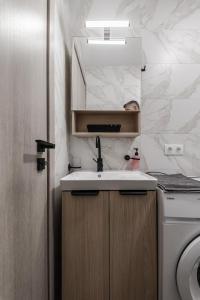 a bathroom with a sink and a toilet at ZoYa`s Apartments in Agria +174 photos