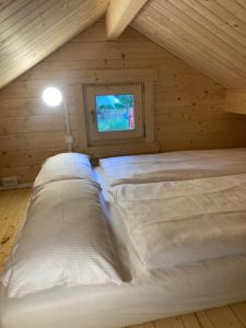 a bedroom with two beds in a attic at Tiny House Seeblick in Casel