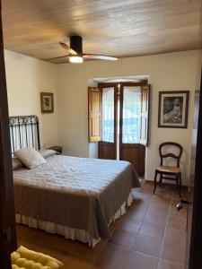 a bedroom with a bed and a chair at Cal Nicet in Perafita