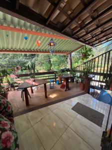 a patio with tables and benches and a pool at Arandú Hostel in Itacaré