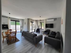 a living room with couches and a dining room at Duplex Villa with Private Pool in Akyaka Ataköy in Muğla