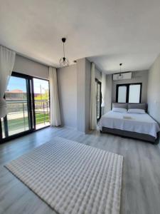 a large bedroom with a bed and a large window at Duplex Villa with Private Pool in Akyaka Ataköy in Muğla +18 photos