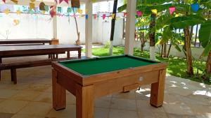 a pool table sitting inside of a room with at Casa Signore Ventoforte in Caucaia
