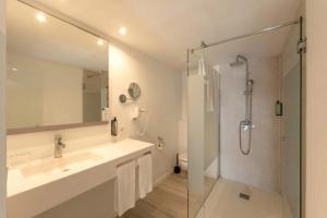 a white bathroom with a sink and a shower at hotel apartamento es Talaial in Cala d´Or