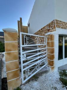 a metal gate on the side of a building at Chez Julia in Brech +2 photos