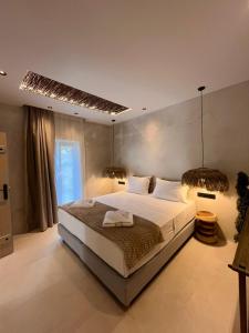 a bedroom with a large bed and a window at Naxos Green Village Hotel in Naxos Chora +156 photos