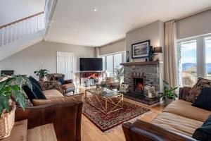 a living room with couches and a fireplace at The Iveragh in Kenmare