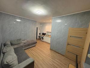 a living room with a couch and a kitchen at Appart 4 personnes in Lille