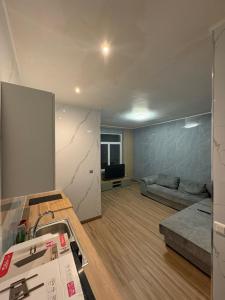 a living room being remodeled with a couch in it at Appart 4 personnes in Lille