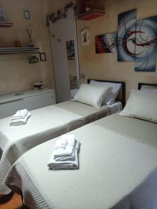 two beds sitting next to each other in a room at La RIVISTA in Manduria