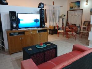 a living room with a couch and a flat screen tv at El Camino in Gardey