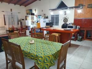 a dining room with a table and a kitchen at El Camino in Gardey