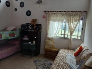 a dorm room with a bed and a window at El Camino in Gardey