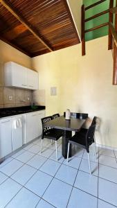 a kitchen with a table and chairs in a room at Pousada Coco Verde Natal in Natal