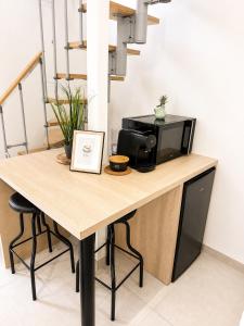 a table with a microwave on top of it at Duplex with private outdoor spa close to Strasbourg city center in Strasbourg