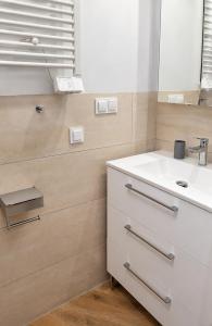 a bathroom with a sink and a mirror at Fairy- tale house in Przeróbka in Gdańsk
