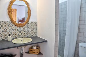 a bathroom with a sink and a mirror at Monte Dos Avós in Mourão +13 photos