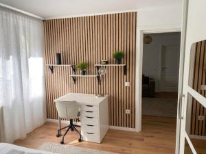 a bedroom with a desk and a bed and a room at Marc Apartament in Turda