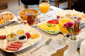 a table with breakfast foods and glasses of orange juice at Terrace Hotel in Istanbul